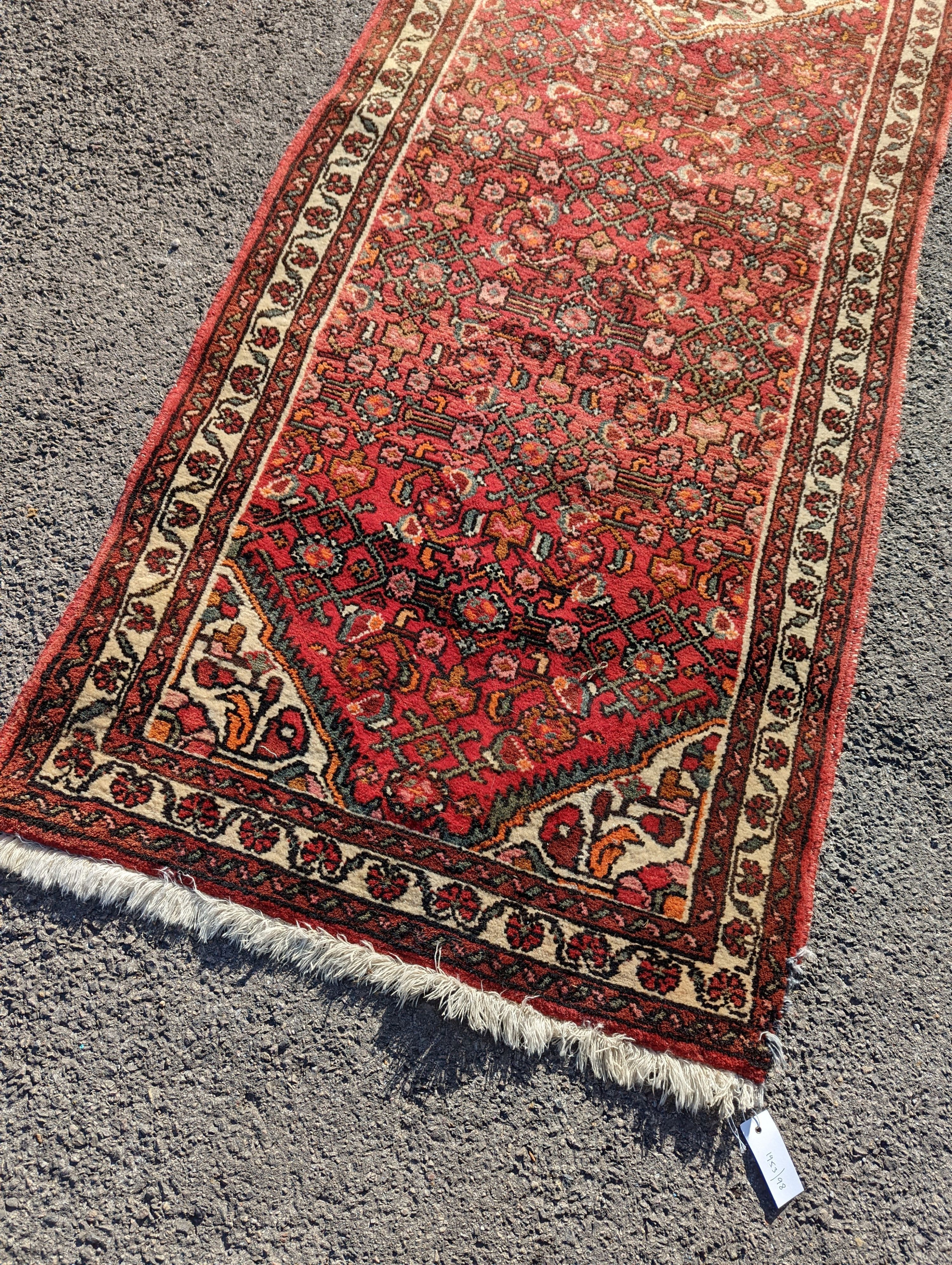 A North West Persian red ground runner, 290 x 82cm